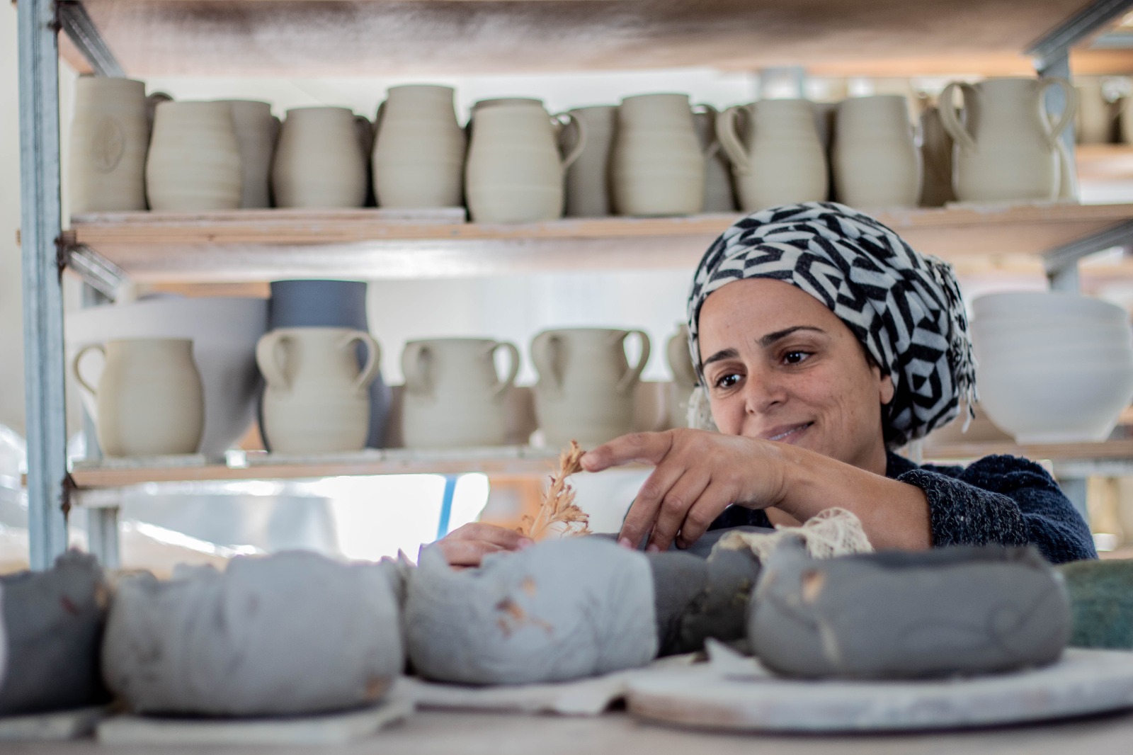 Batya Erdstein at her pottery wheel
